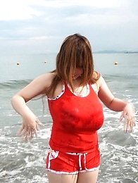 she takes off the shirt and goes swimming to the sea in a small bikini.