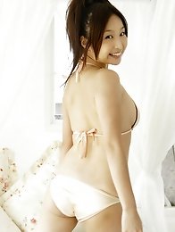 Bouncey asian beauty playfully shows off her plump tits in bikini