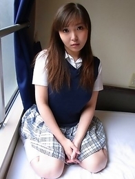 Haruka Ohsawa posing in her schoolgirl uniform and hiking up her top to show her big boobs